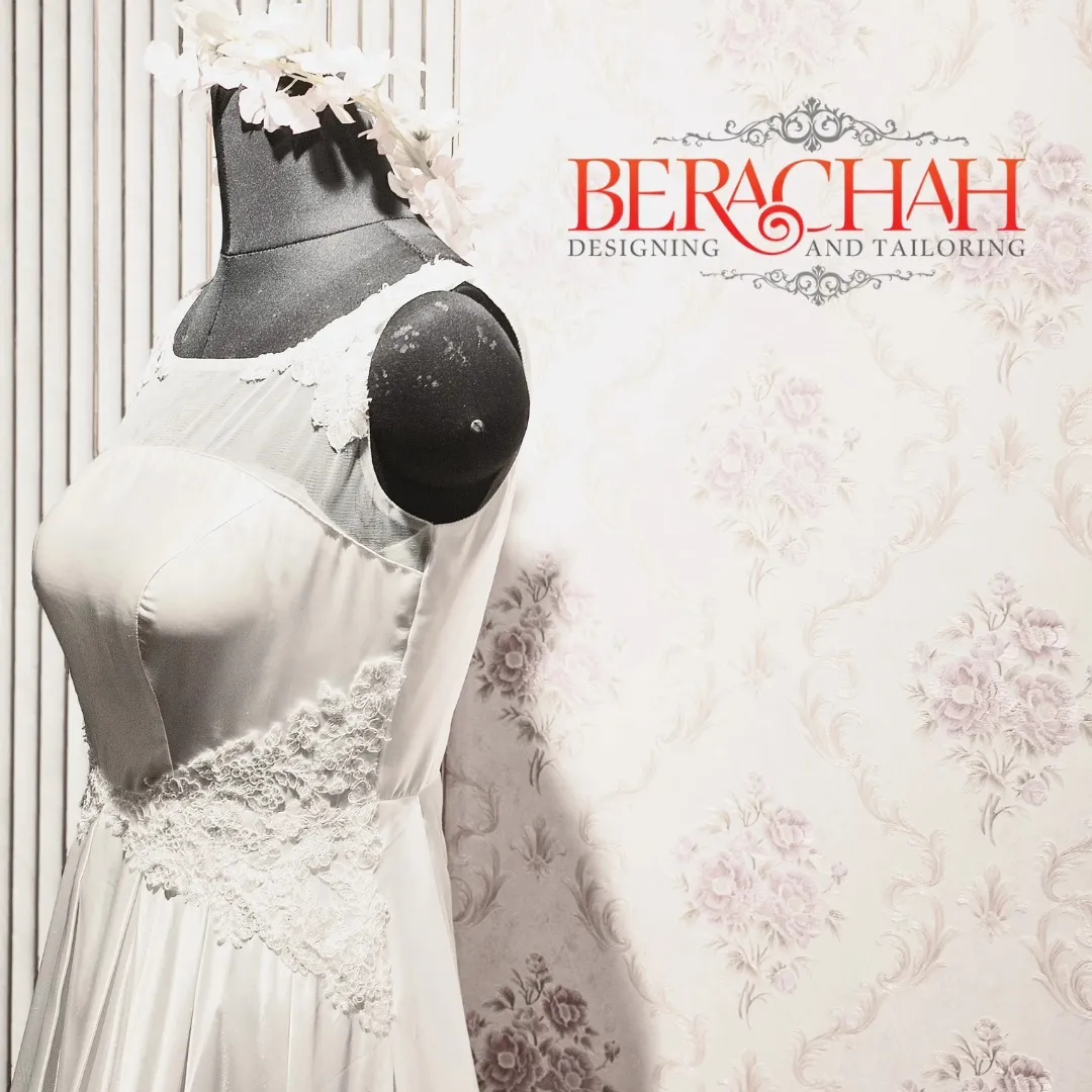 Ivory gown with hand-applied lace on a mannequin in the Berachah studio