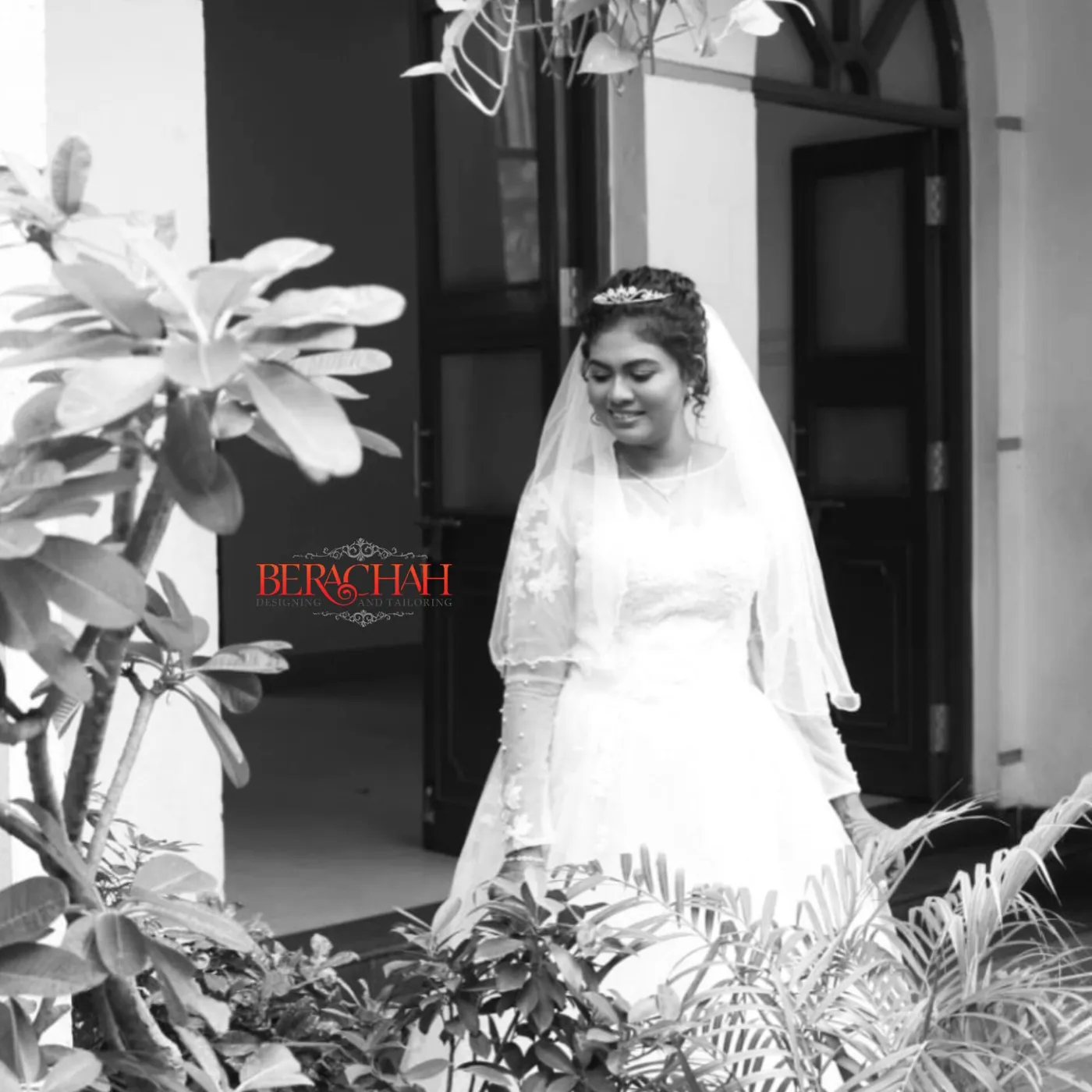 Black-and-white portrait of a bride in a church doorway
