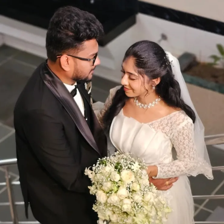 Bride and groom embracing on a staircase